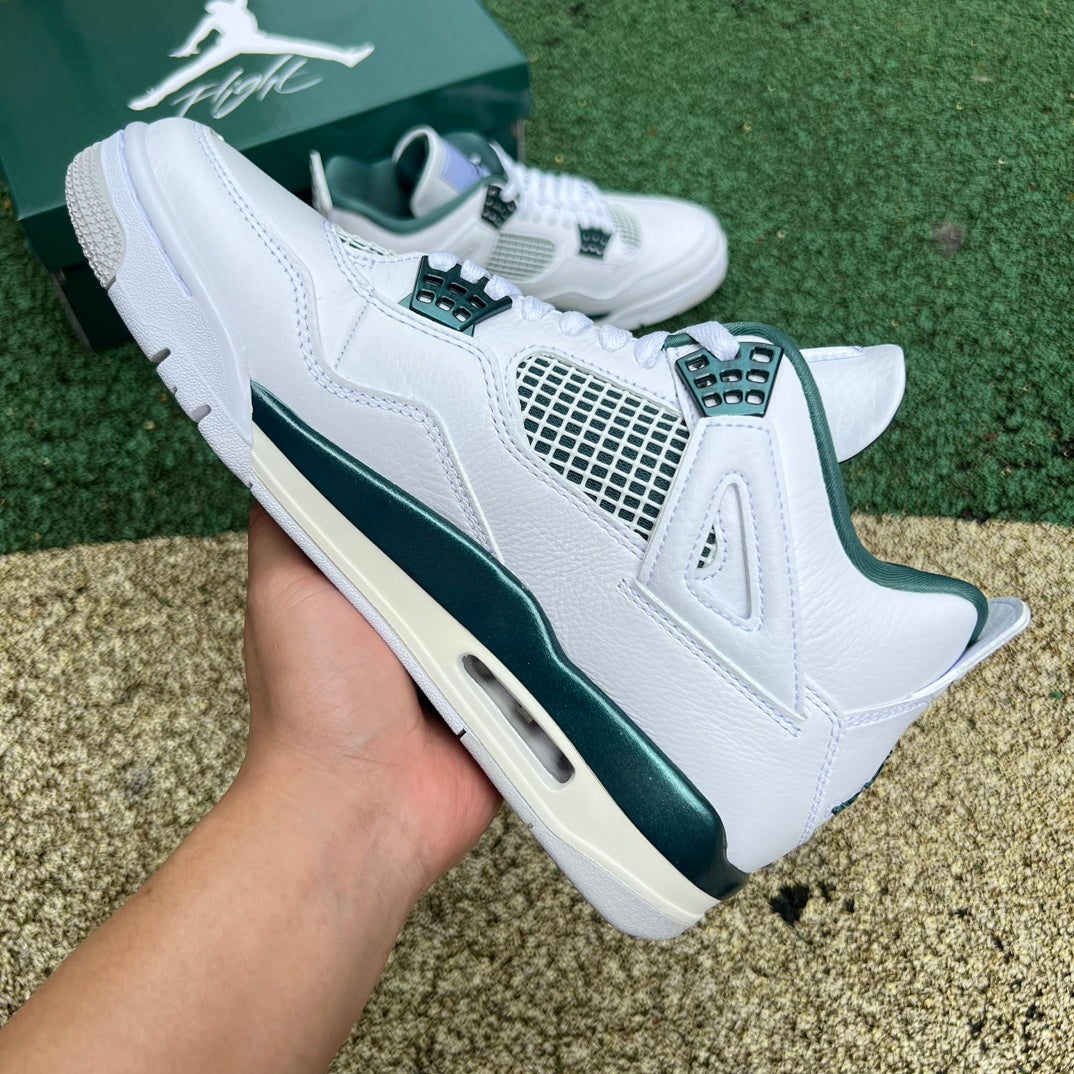 Nike Air Jordan 4 Retro Oxidized Green sneakers with white accents, showcasing the classic design and Nike x Jordan branding.