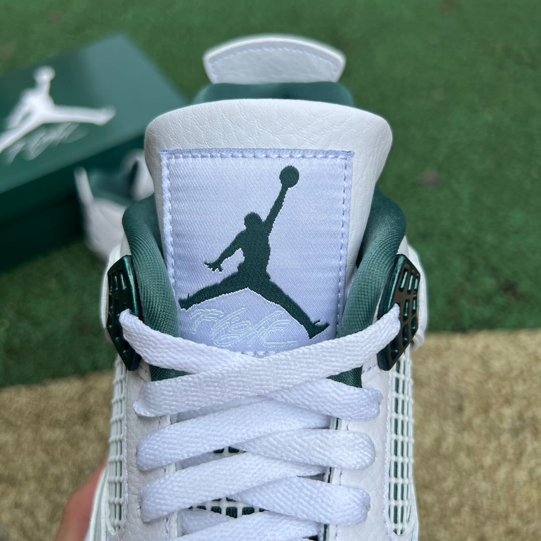 Nike Air Jordan 4 Retro Oxidized Green sneakers with black accents and white midsole, displayed on a plain background.