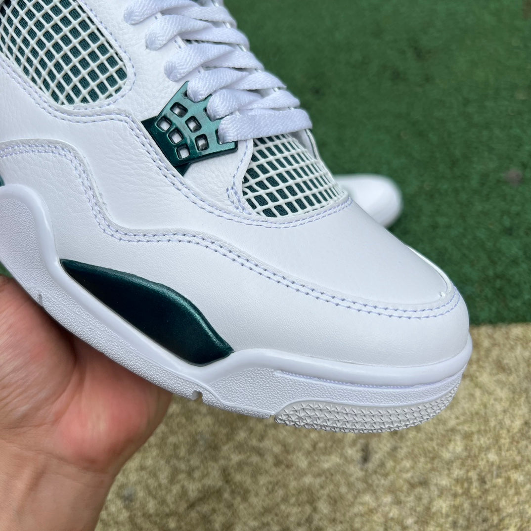 Nike Air Jordan 4 Retro Oxidized Green sneakers in white and green with detailed design and signature Jordan branding.