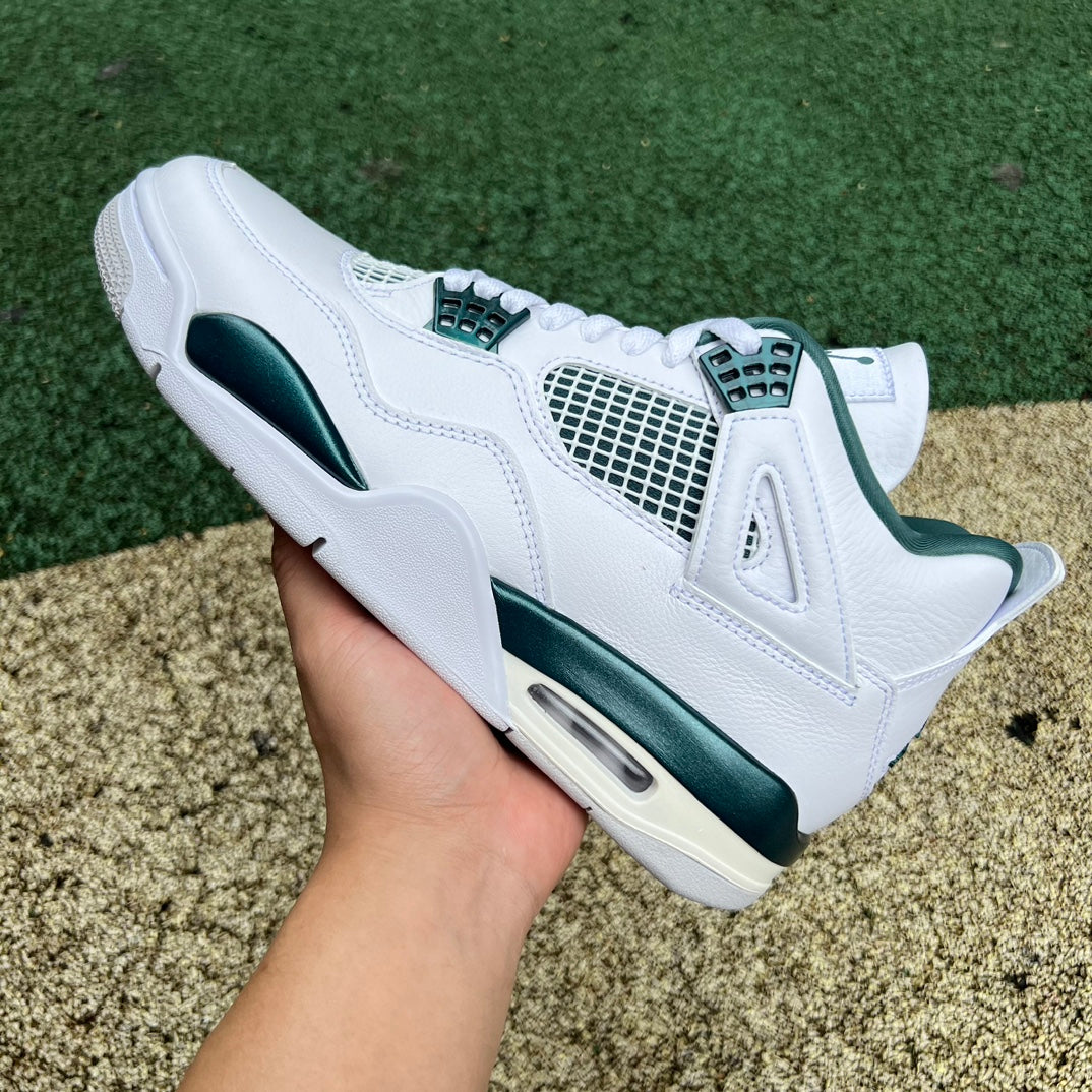 Nike Air Jordan 4 Retro Oxidized Green sneakers featuring green and black colorway, crafted by Nike x Jordan.
