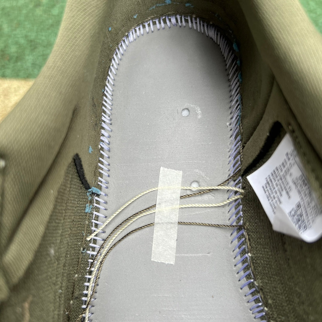 Nike Air Jordan 1 Retro Low OG SP Travis Scott sneakers in Medium Olive, featuring signature design details and brand logo.