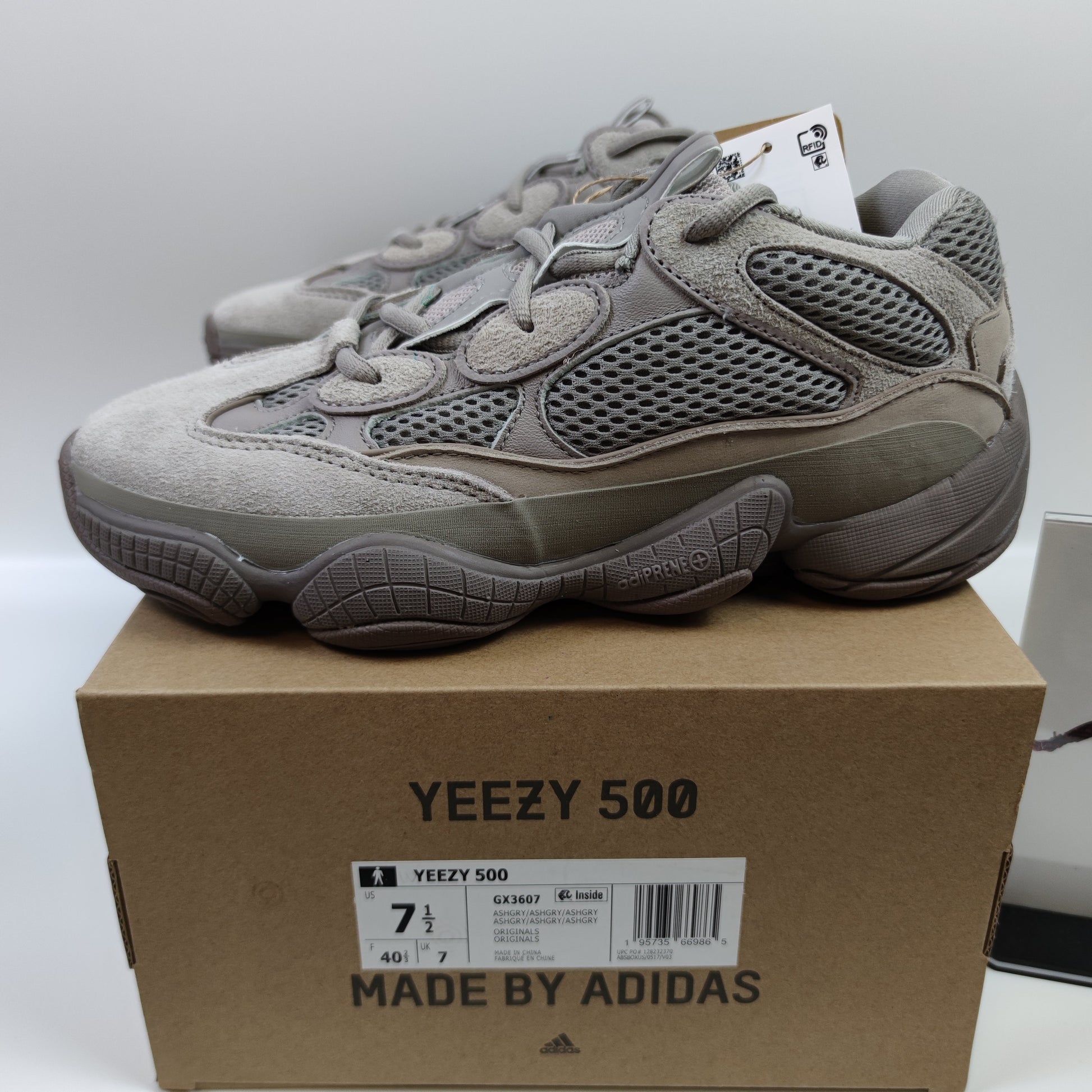 Adidas Originals Yeezy 500 Ash Grey sneaker, side view showing grey suede and mesh upper, chunky sole, and Yeezy branding.
