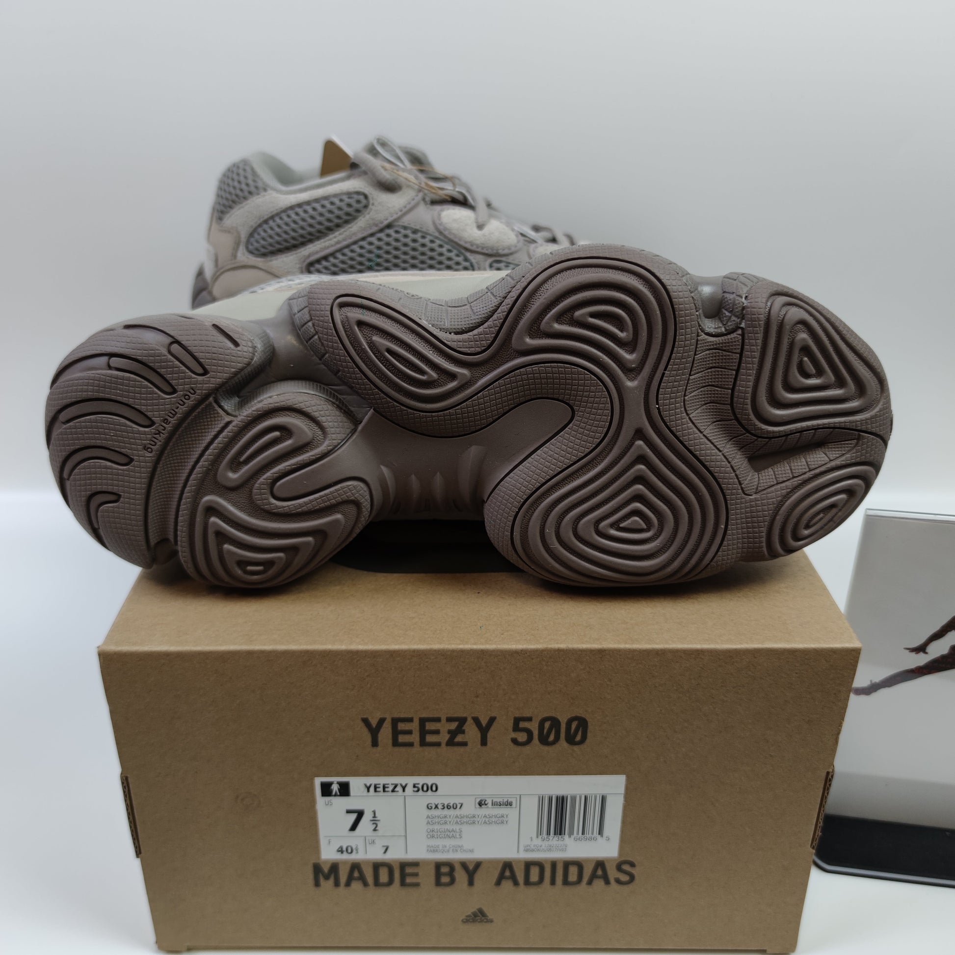 Adidas Originals Yeezy 500 Ash Grey sneakers with grey suede and mesh upper, chunky sole, and Adidas branding.